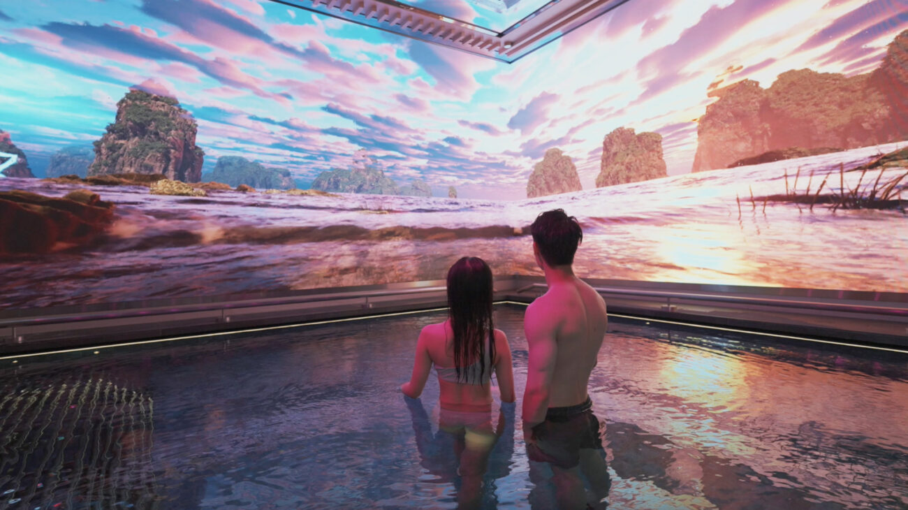 A couple stands in water within the Tria Spa experience at MGM Grand Macau, watching tropical storm video content created by experience studio S1T2.