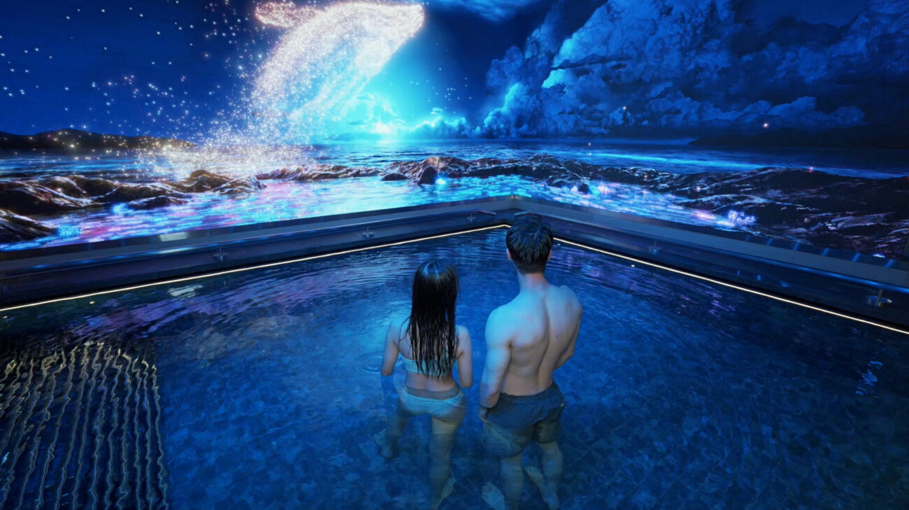A couple stands in water, immersed in the multisensory spa experience created by S1T2 and Blue Alchemy Labs for MGM Grand, Macau.